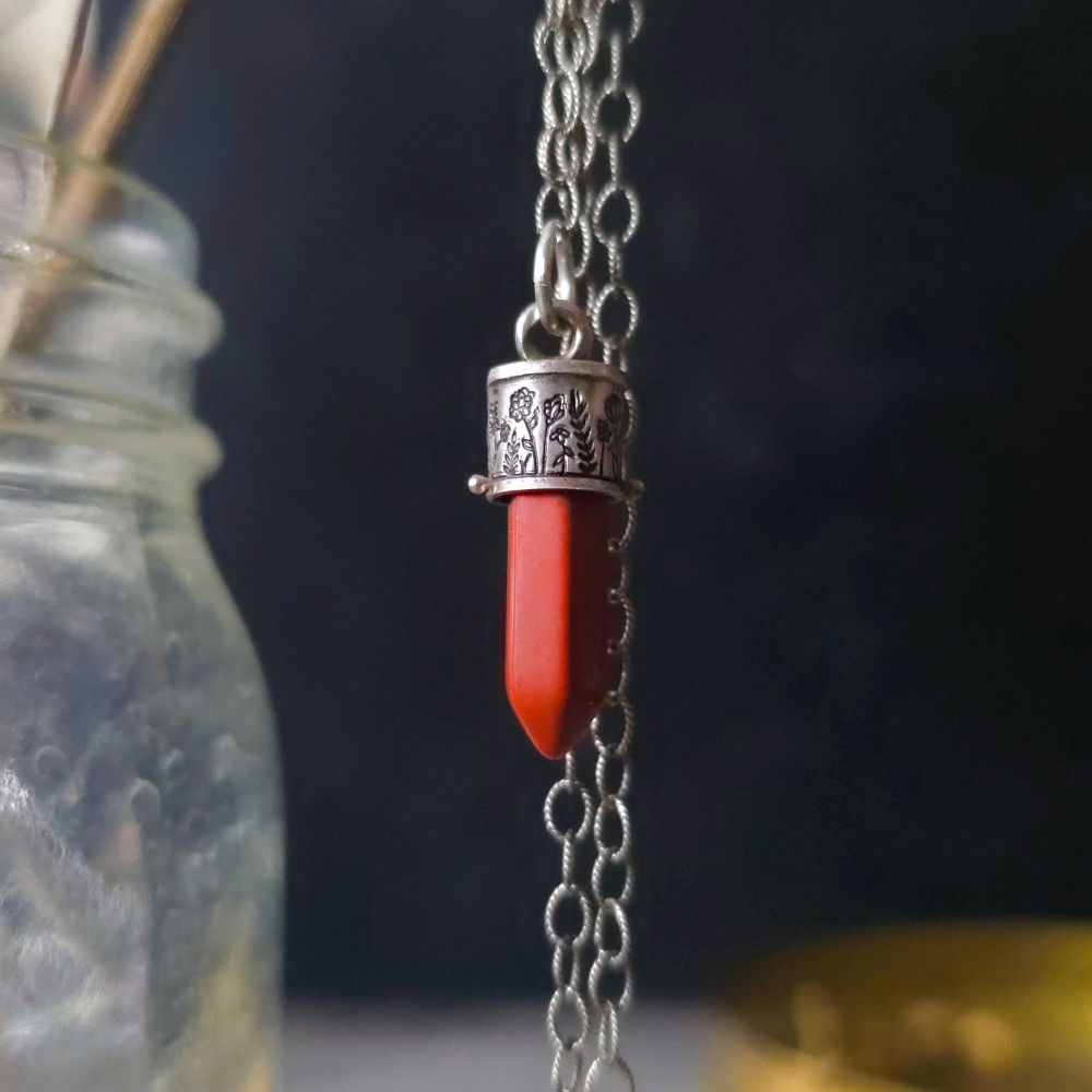 Sterling Silver Wildflowers Lucidity Charm with red jasper and silver chain against a dark background