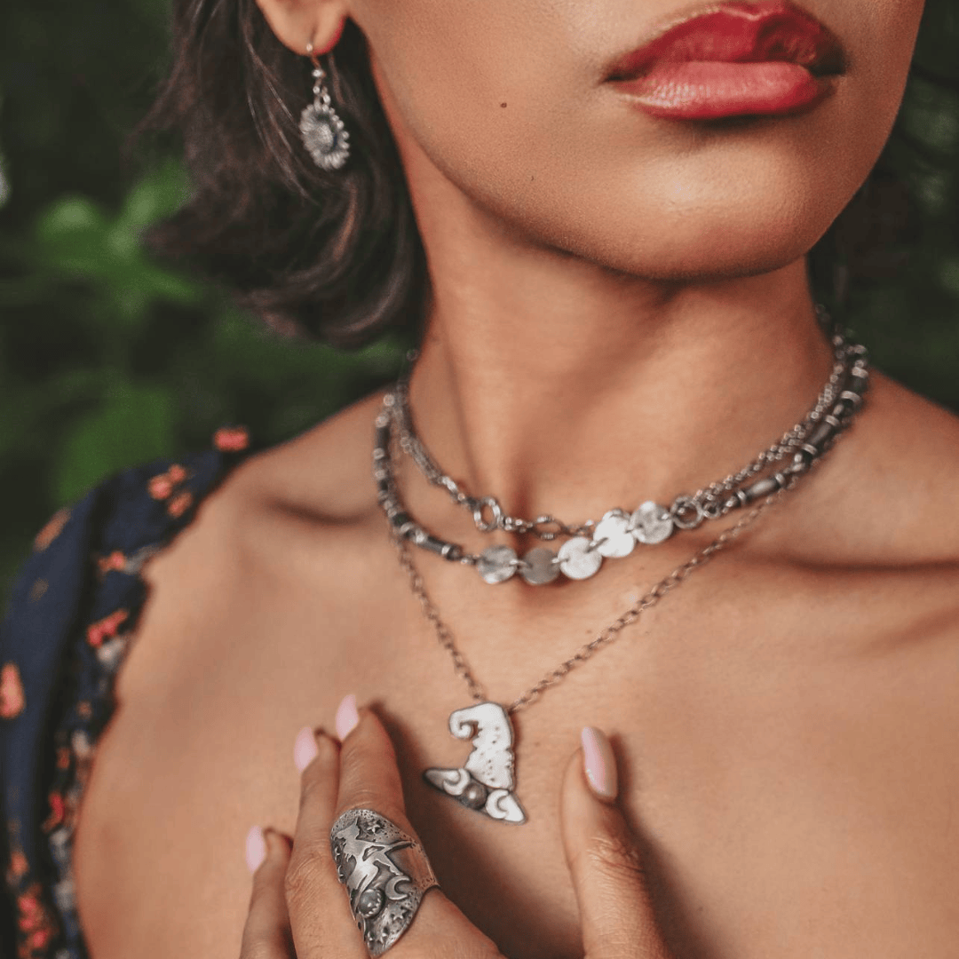 Layered necklace styling featuring a witch hat pendant with labradorite