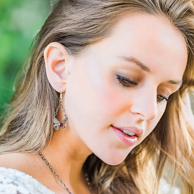 Sterling Silver Butterfly Earrings with Garnet Gemstone photographed on a model