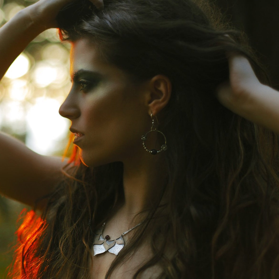 Lotus Statement Necklace with Garnet sterling silver and brass photographed on a model side view