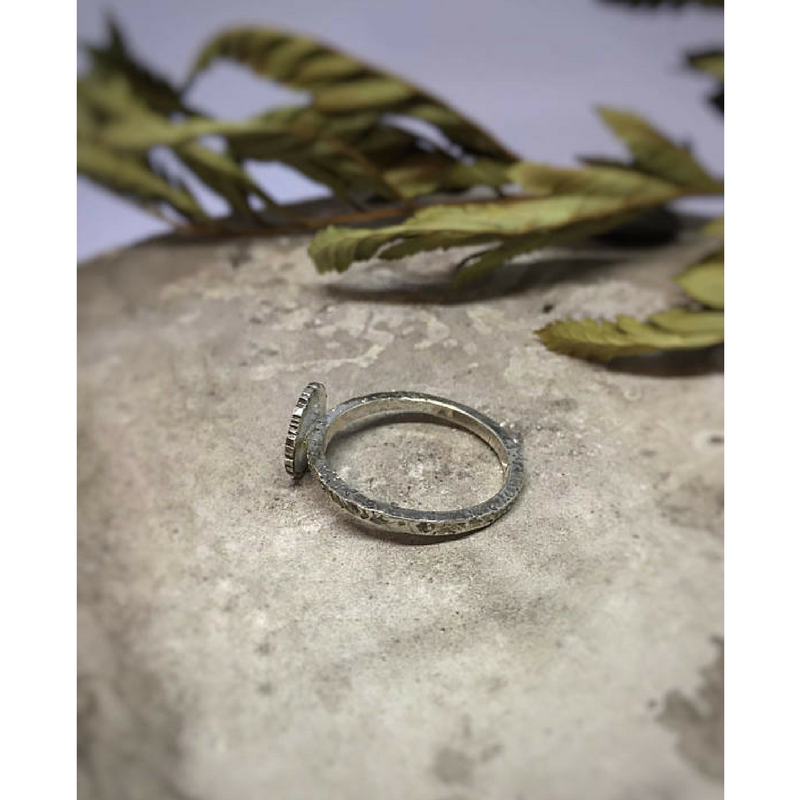 Moon and Star Celestial Ring side view photographed on a stone with dried leaves at the background
