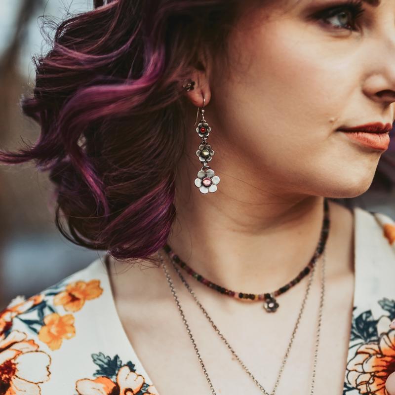 Crescent moon earrings with lotus and chrome diopside stone photographed on a model
