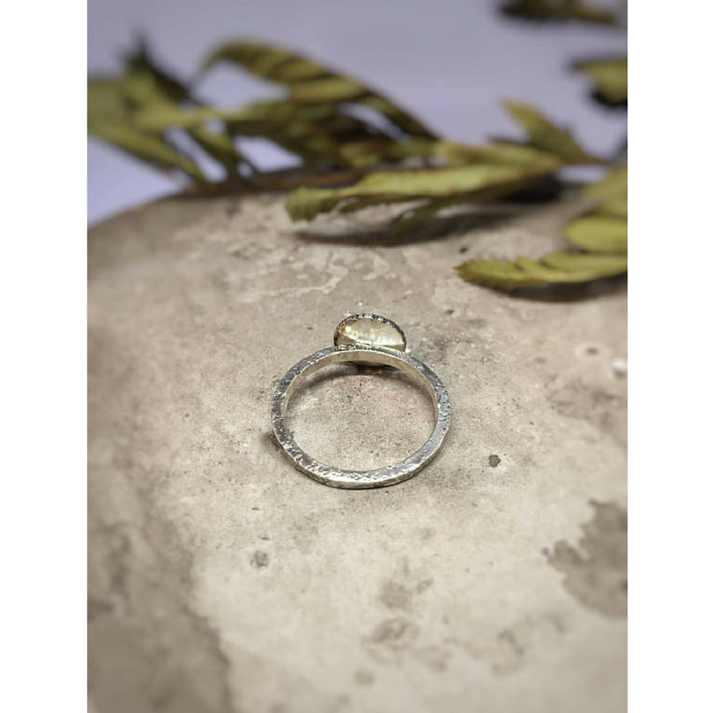 Moon and Star Celestial Ring back view photographed on a stone with dried leaves at the background
