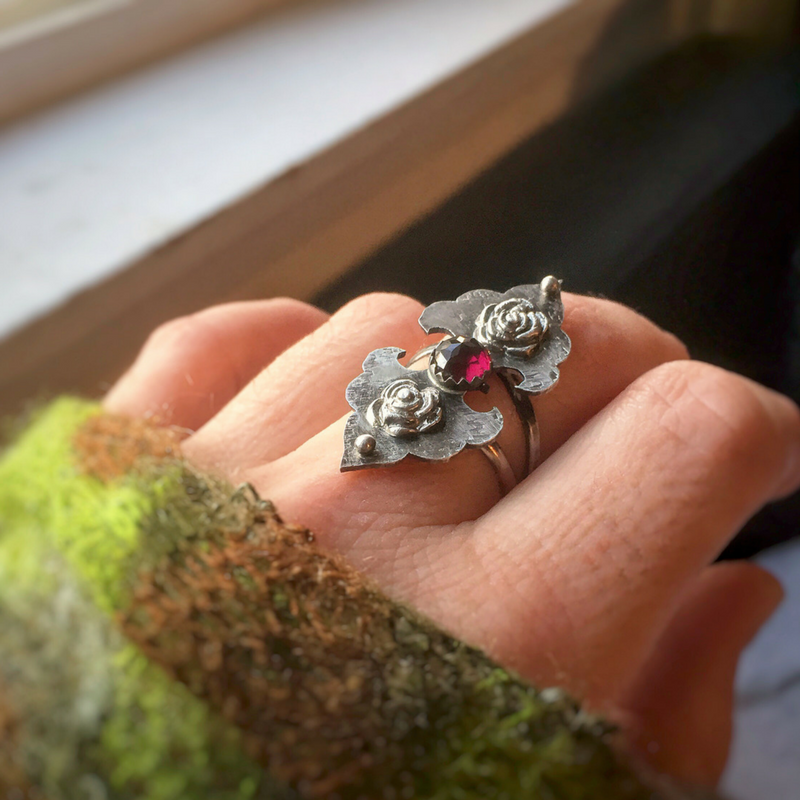 Rosebuds Flower Statement Ring with Garnet top view photographed on finger
