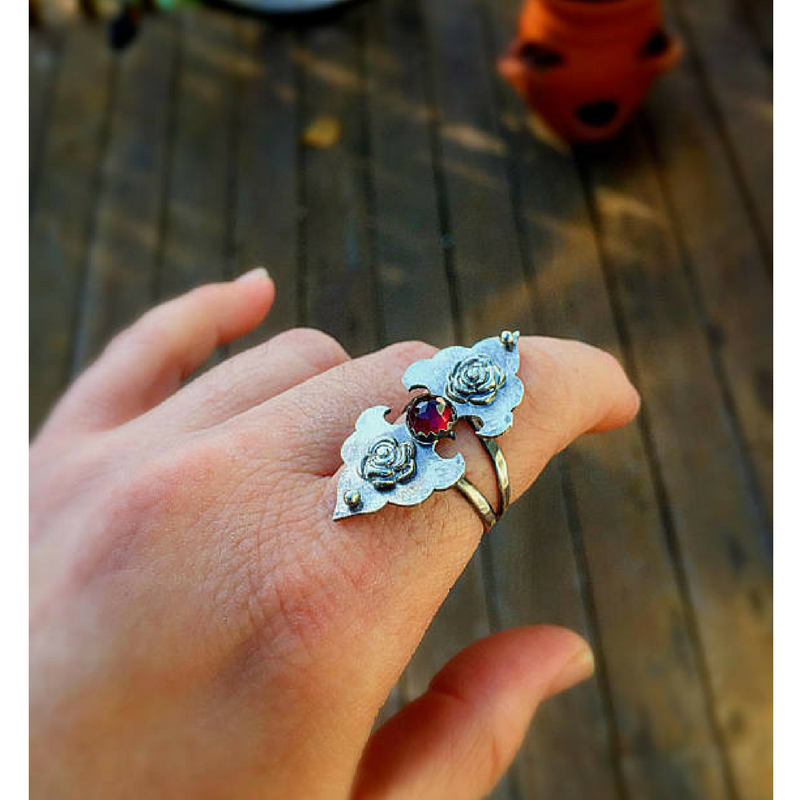 Rosebuds Flower Statement Ring with Garnet top view photographed on a finger