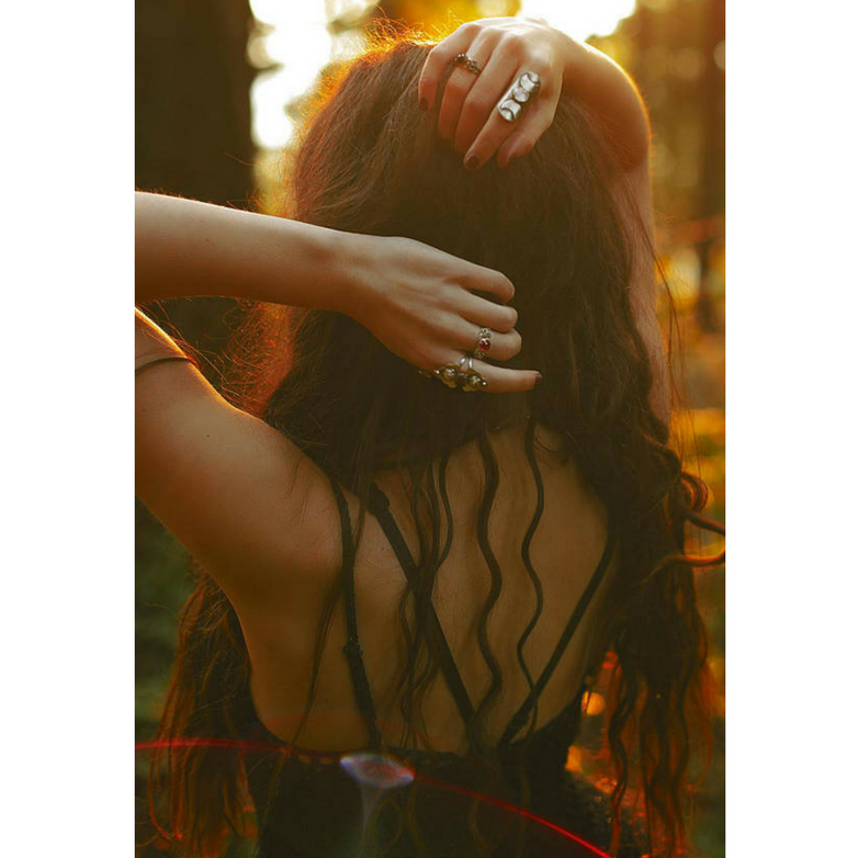 Rosebuds Flower Statement Ring with Garnet photographed on a model stylized photo with other rings